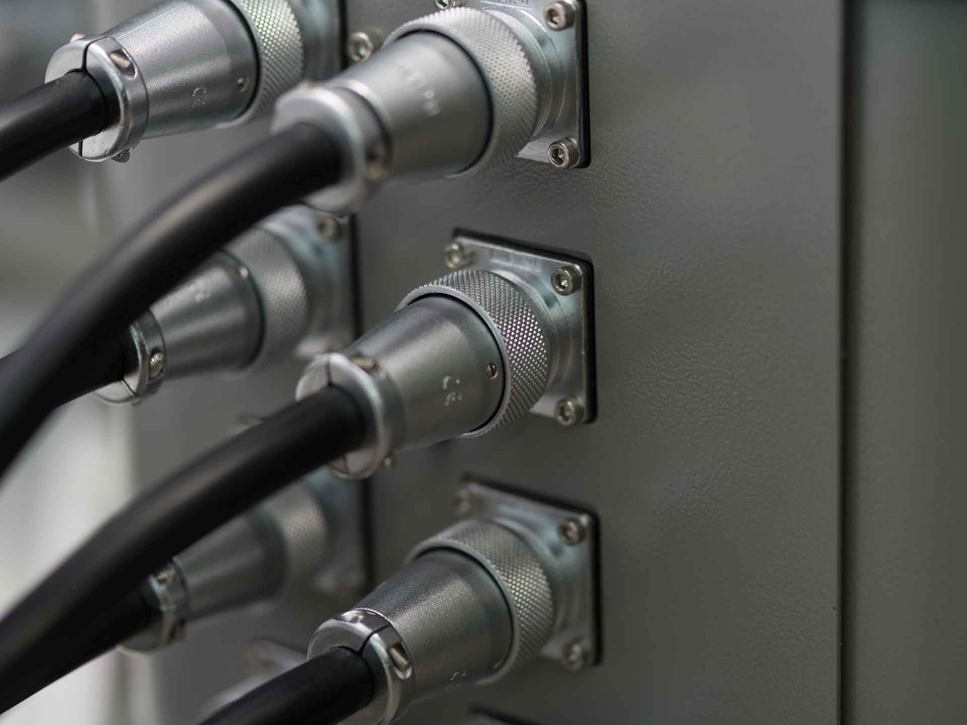 Close-up of a panel displaying multiple colorful electrical wires interconnected and organized.
